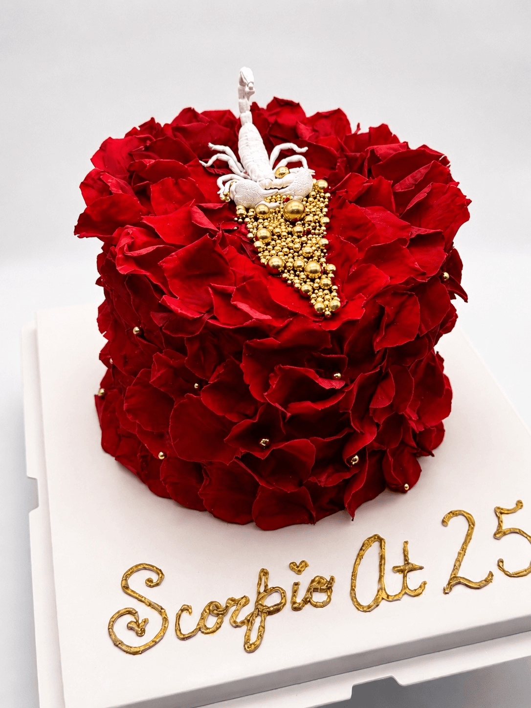 Decorated celebration cake with frosting and sliced layers.