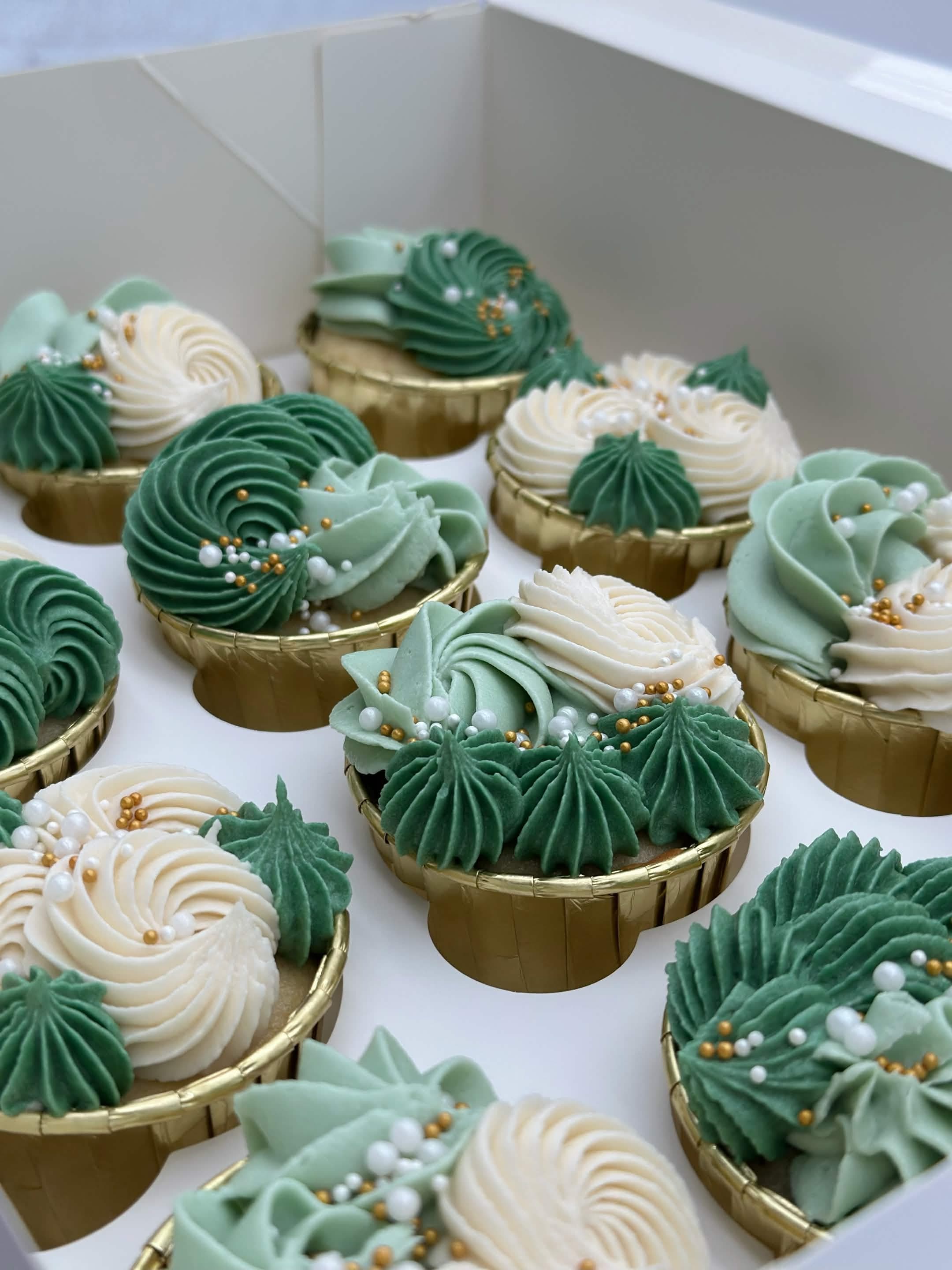 Assorted cupcakes topped with swirls of frosting.