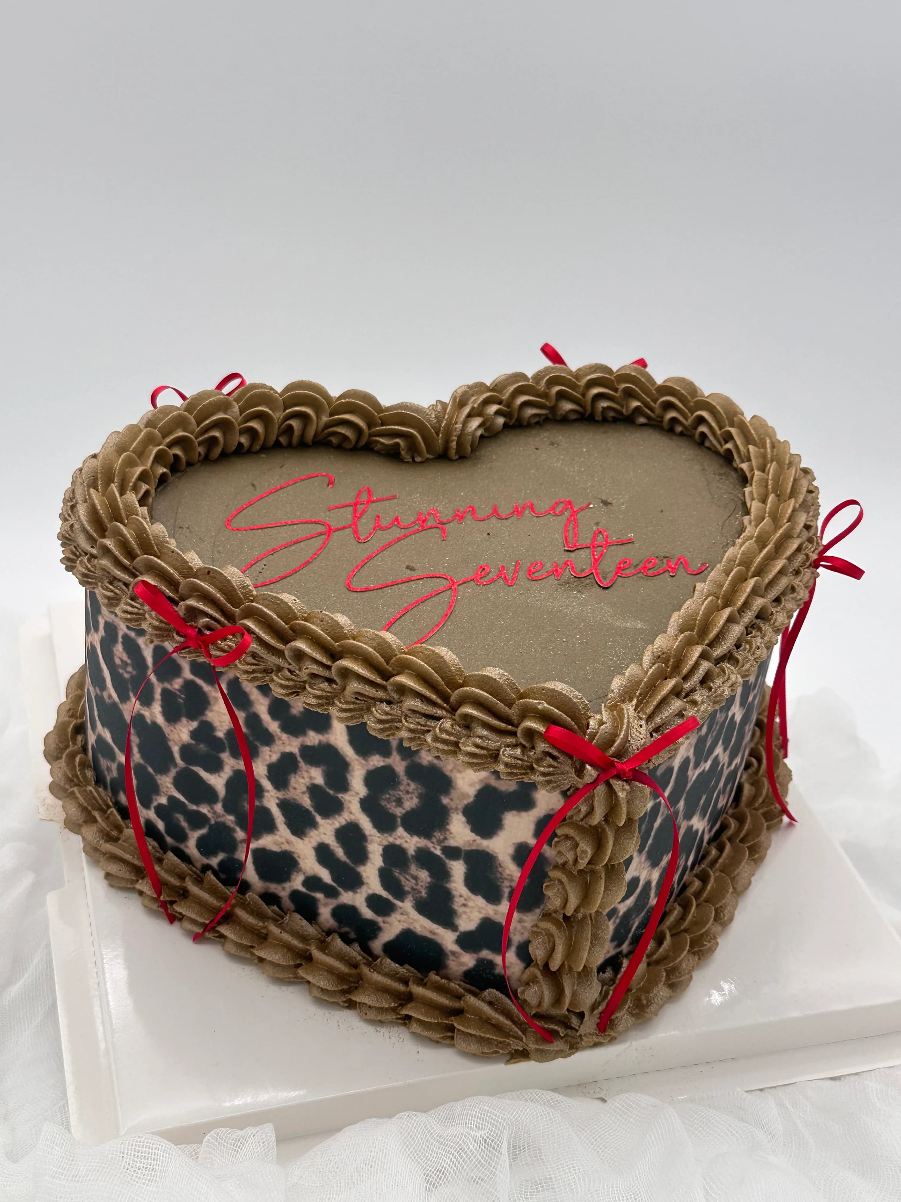 A frosted cake with candles and colorful celebration details.